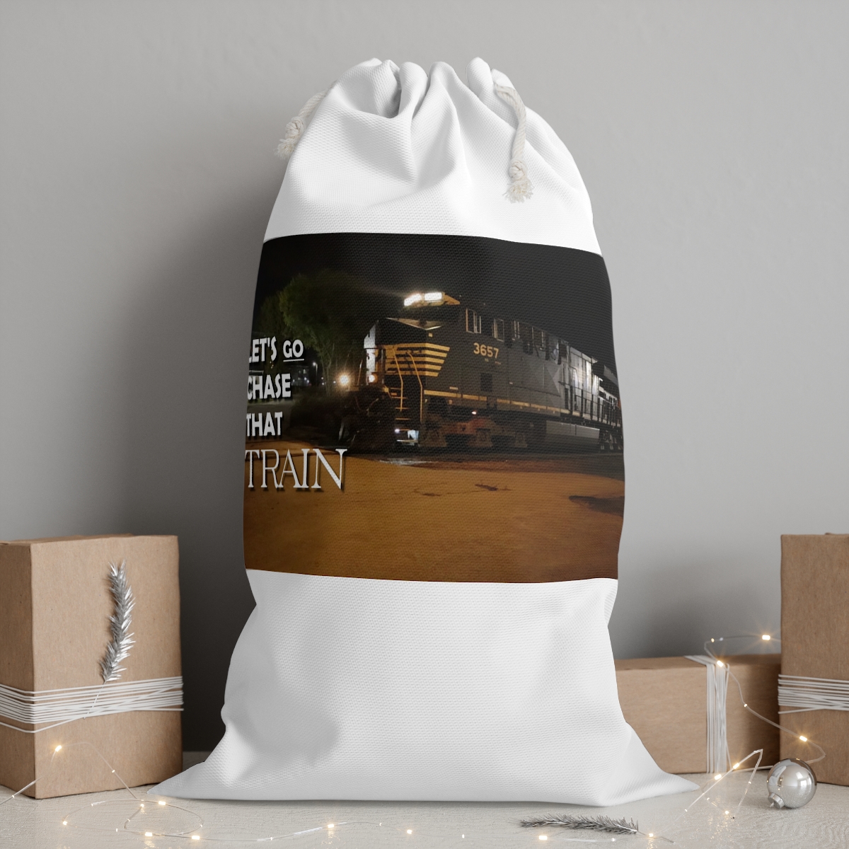 White drawstring bag with night train image and text “Let’s Go Chase That Train”