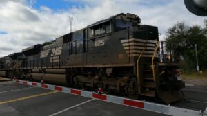 orfolk Southern locomotive 1125 stopped at railroad crossing gate